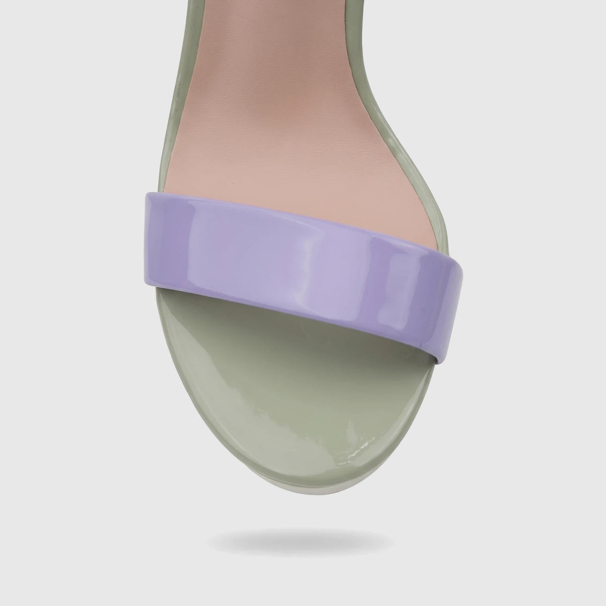 Close-up of a Bulbul ladies casual slingback sandal in light purple and green, featuring a glossy wide toe strap and footbed.