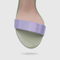 Close-up of a Bulbul ladies casual slingback sandal in light purple and green, featuring a glossy wide toe strap and footbed.