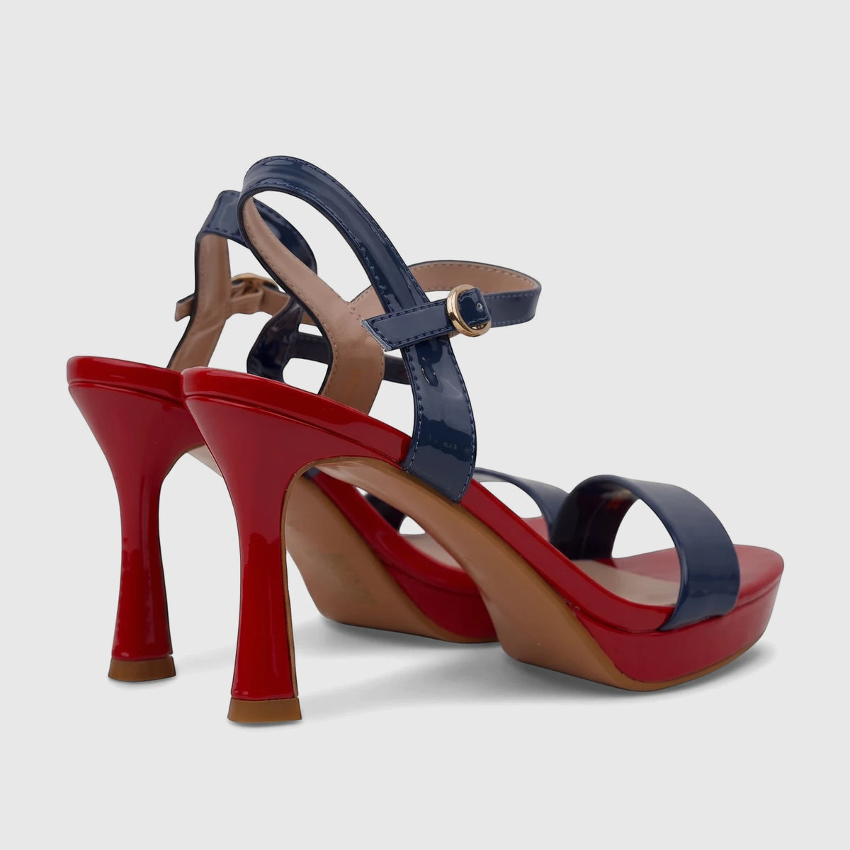 A pair of Bulbul Ladies Casual Slingback Sandals featuring glossy red high heels and platforms with navy blue patent leather