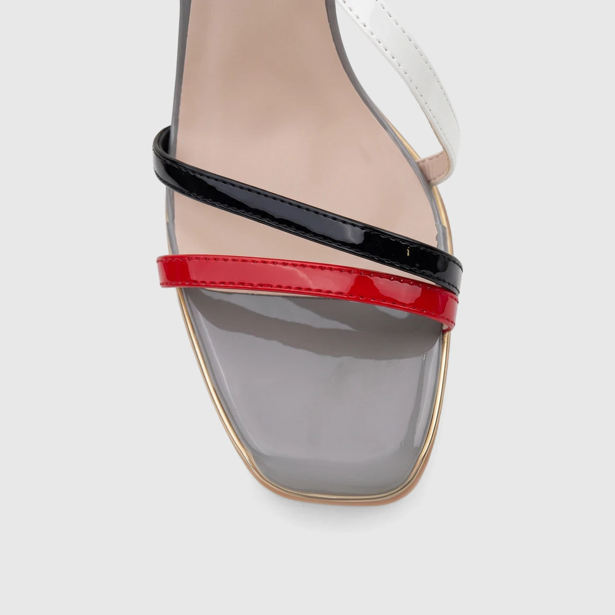Close-up of a Bulbul Ladies Casual Slingback Sandal featuring red, black, and white patent leather straps with a grey