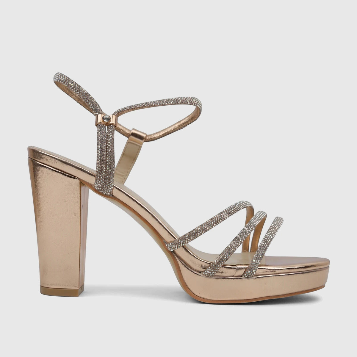 A side view of a champagne block heel sandal adorned with rhinestone-embellished straps, perfect for evening wear.