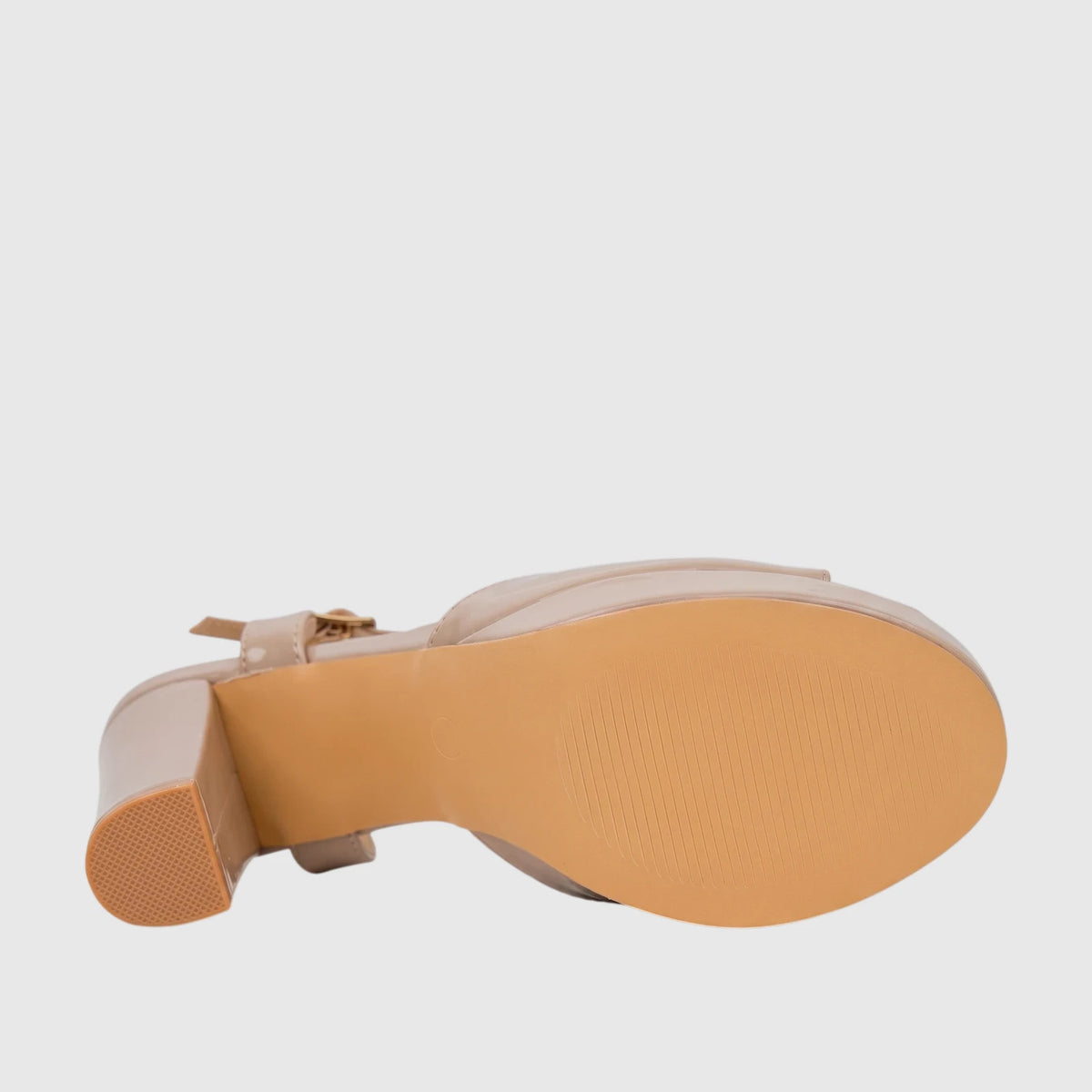Bulbul Ladies Dress Block Heel Sandal in beige patent leather, shown from the bottom view, revealing the sole and heel.