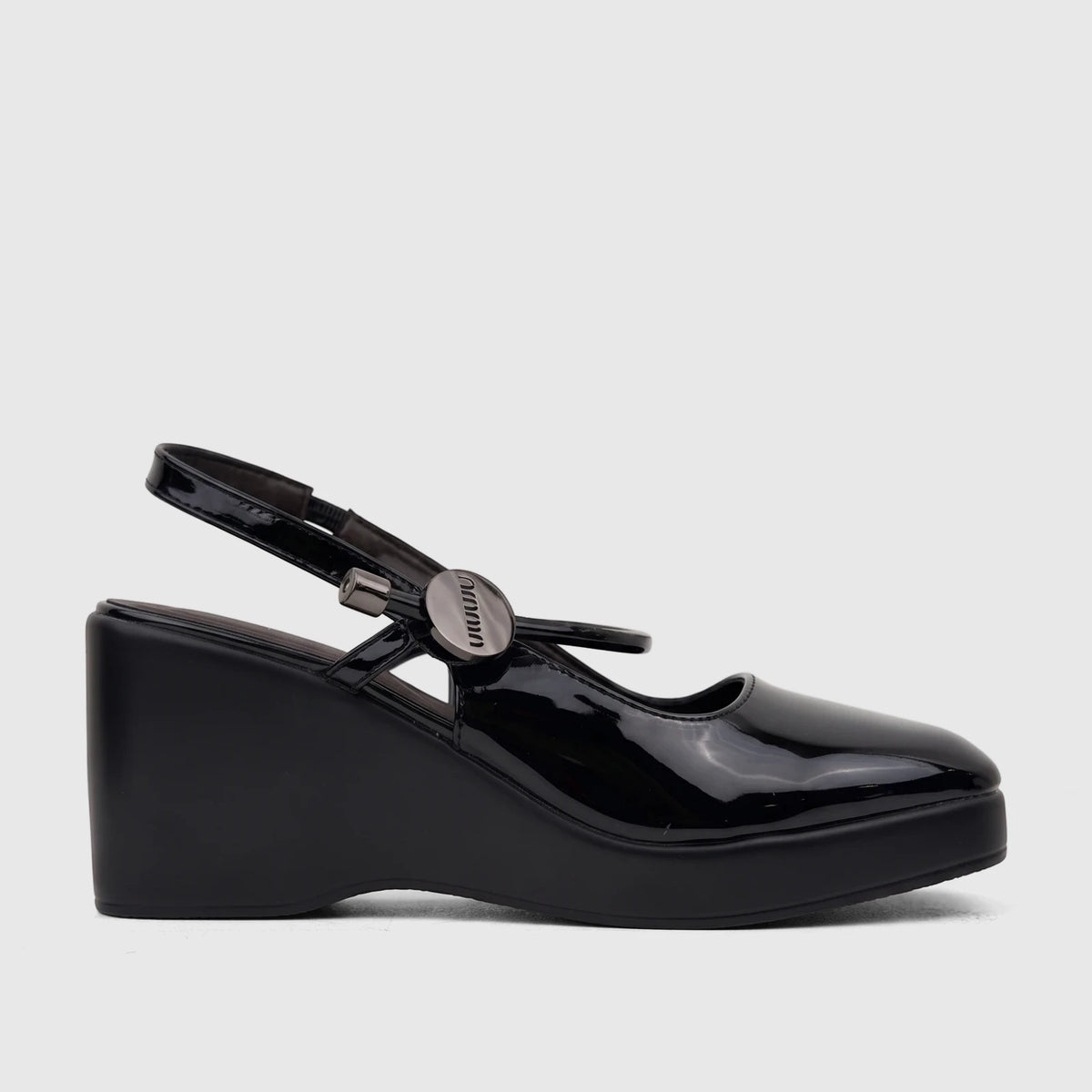 Black patent leather Bulbul Ladies Dress Block Heel Sandal, side view. Features closed-toe pump, wedge platform, and