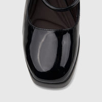 Close-up front view of a shiny black patent leather Bulbul Ladies Dress Block Heel Sandal, showcasing its glossy finish and