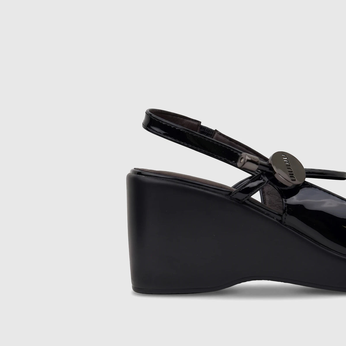 Close-up of a black patent leather Bulbul ladies dress block heel sandal, featuring a glossy finish and a dark metallic