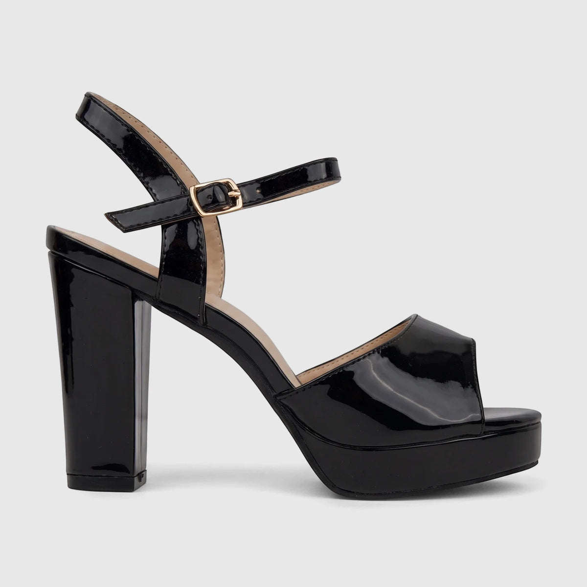 A side view of a black patent leather Bulbul Ladies Dress Block Heel Sandal featuring an ankle strap and gold buckle.