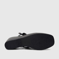 Bottom view of a black Bulbul Ladies Dress Block Heel Sandal, showcasing its textured sole and wedge heel.