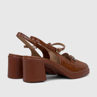 Camel brown patent leather women's dress block heel sandals with ankle straps and a square toe, displayed from a side angle.