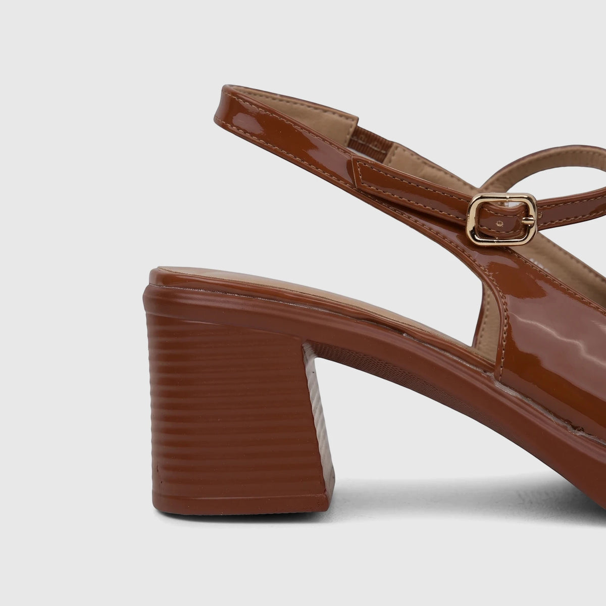 Brown patent leather Bulbul Ladies Dress Block Heel Sandal with an ankle strap and golden buckle, viewed from the side.