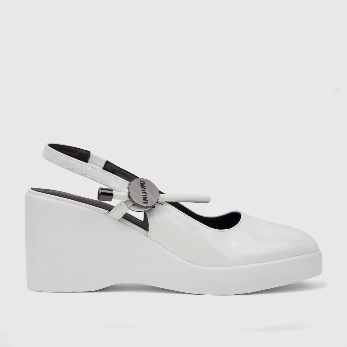 White patent leather Bulbul ladies dress block heel sandal, side view with metallic strap hardware.