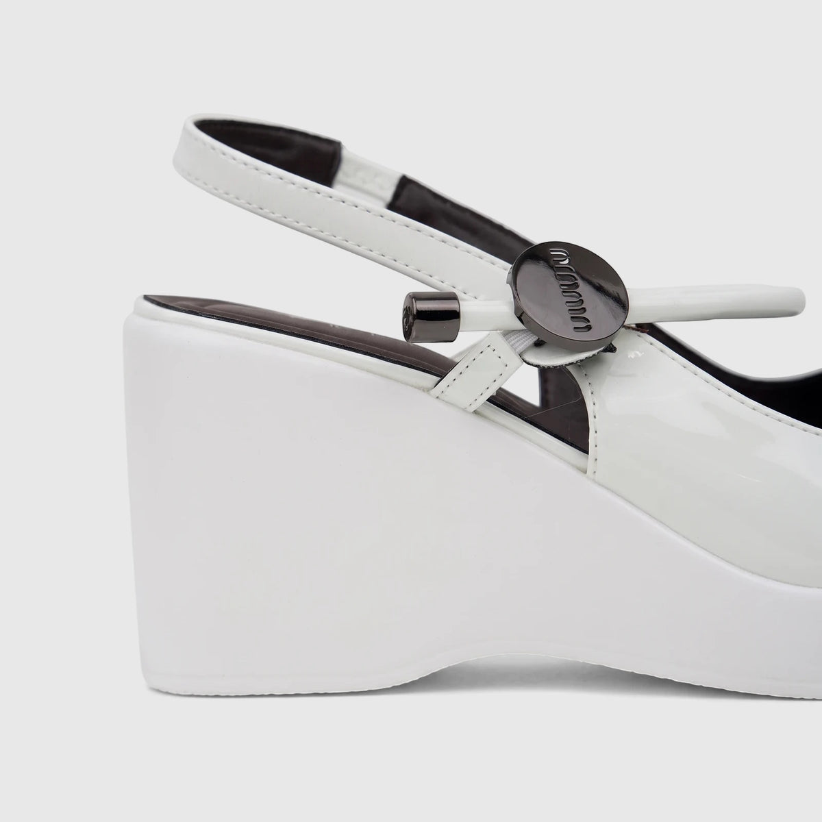 Bulbul Ladies Dress Block Heel Sandal in white patent leather, featuring a high wedge heel and ankle strap, close-up side