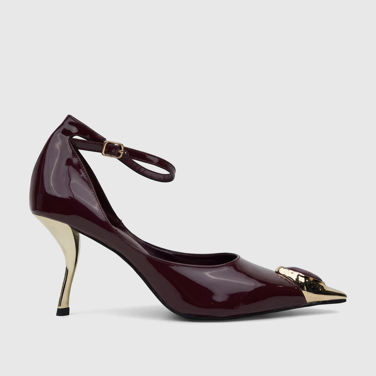 Side view of a Bulbul ladies' dress court shoe with an ankle strap, featuring a glossy purple finish, a golden sculptural