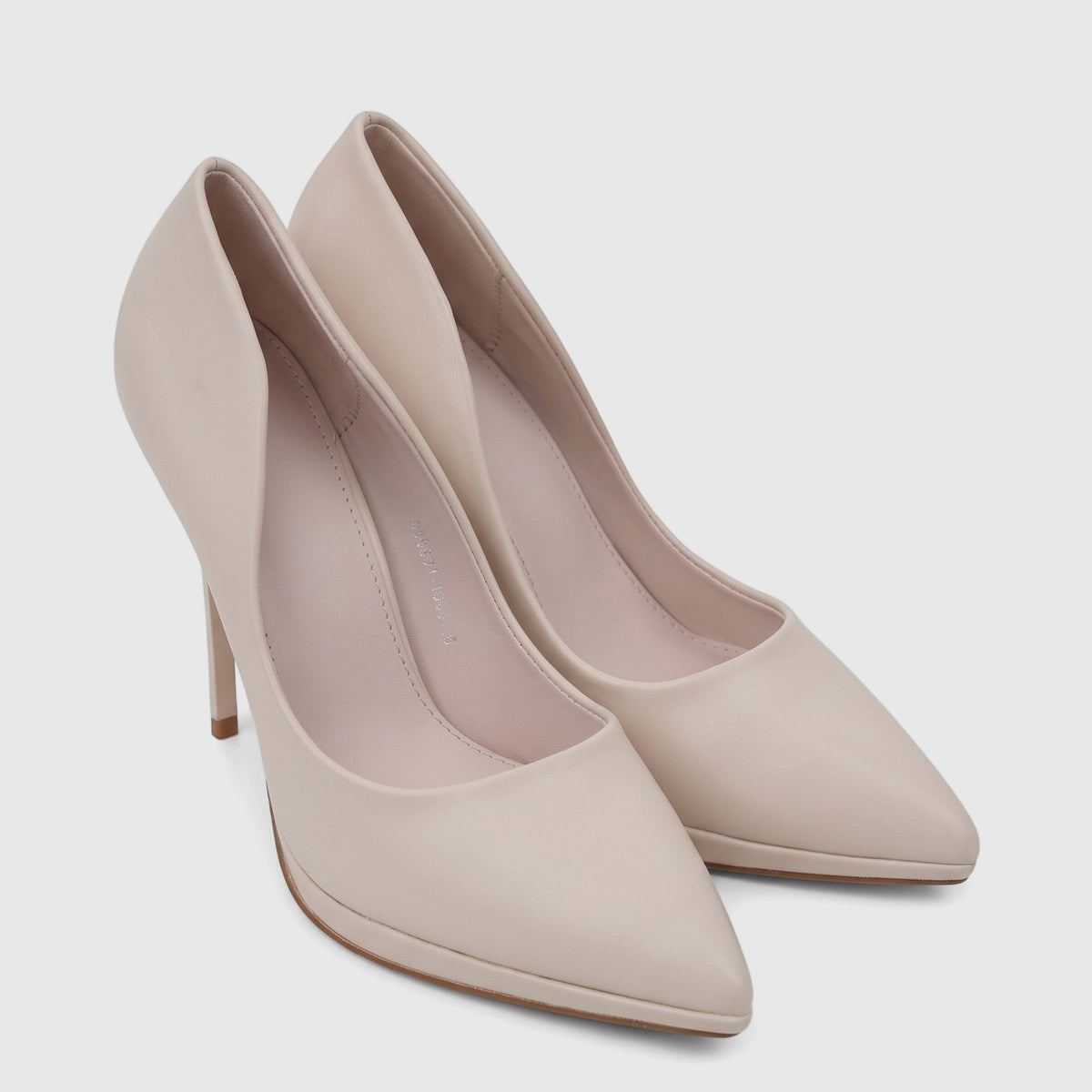 A pair of elegant Bulbul Ladies Dress Court Shoes in beige, featuring a pointed toe and high stiletto heels, made from