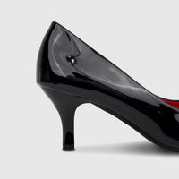 Close-up of a black patent leather kitten heel dress court shoe, featuring a glossy finish.