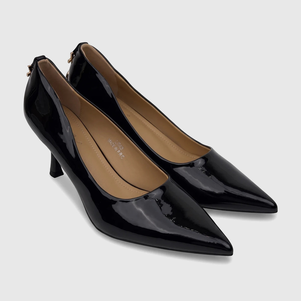 A pair of elegant black patent leather Bulbul ladies dress court shoes, featuring a pointed toe and kitten heel.