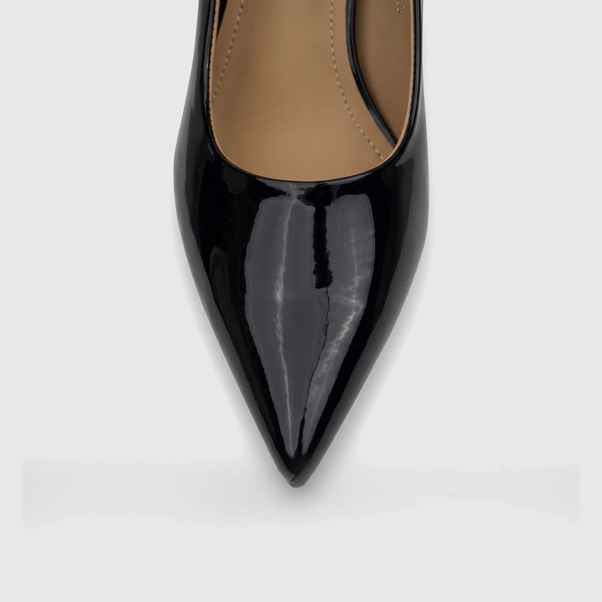 Close-up view of a single black patent leather Bulbul ladies dress court shoe with a pointed toe, showcasing its shiny