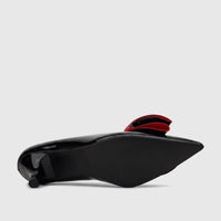 Bulbul Ladies Dress Court Shoe in black patent leather with a red bow, viewed from the side showing the sole and heel.