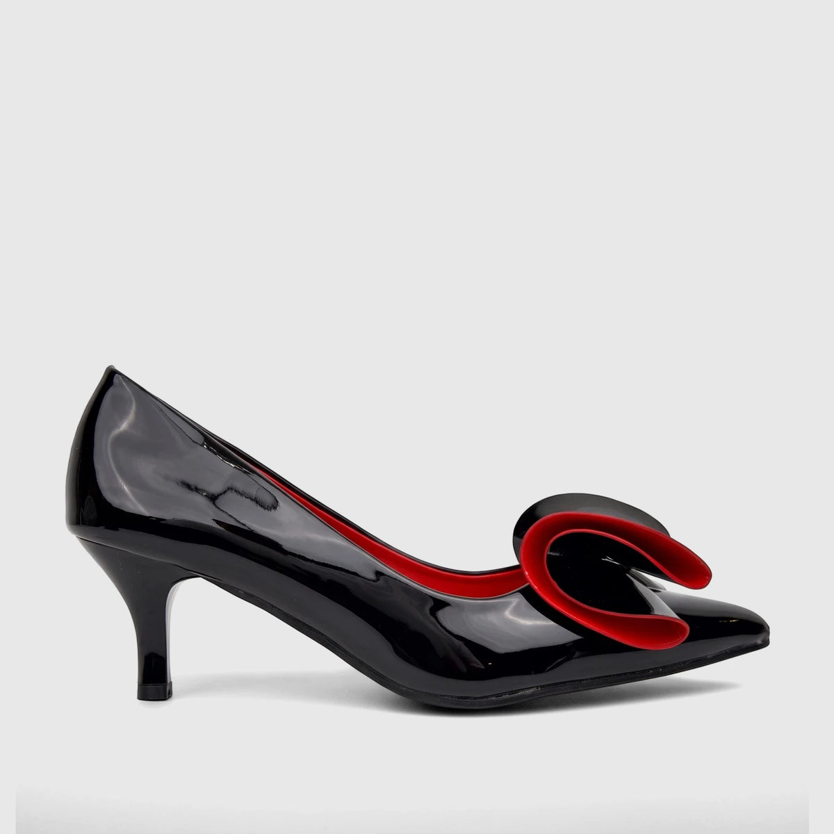 Black patent leather Bulbul ladies dress court shoe with a striking red and black bow detail. An elegant high heel shoe for