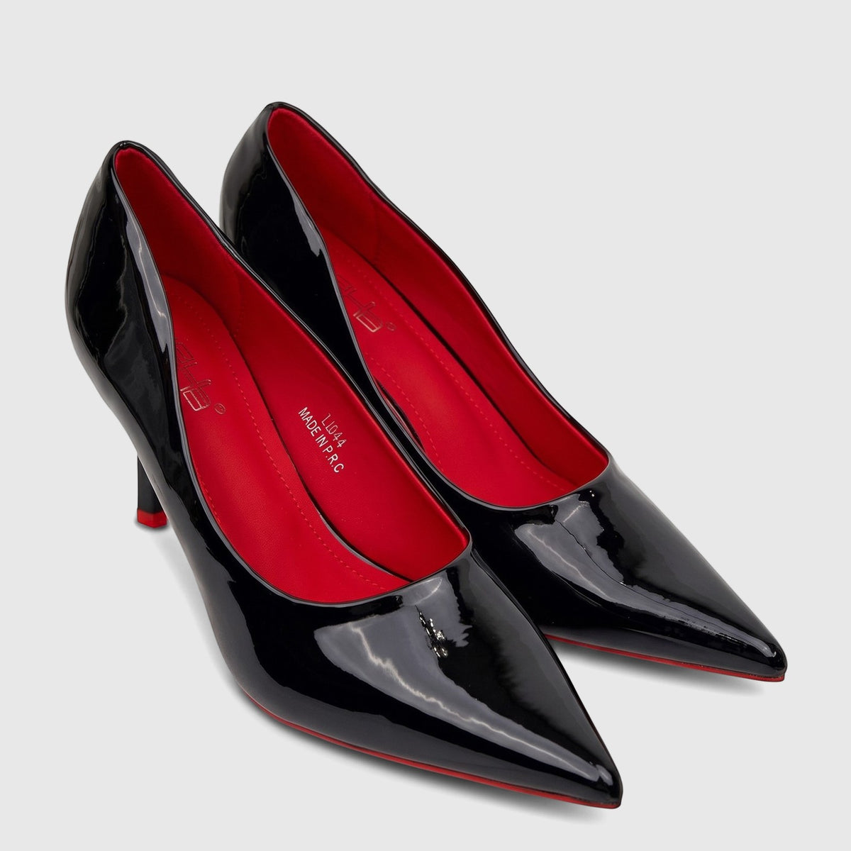 Bulbul Ladies Dress Court Shoes in black patent leather, featuring pointed toes and contrasting red soles, displayed from an