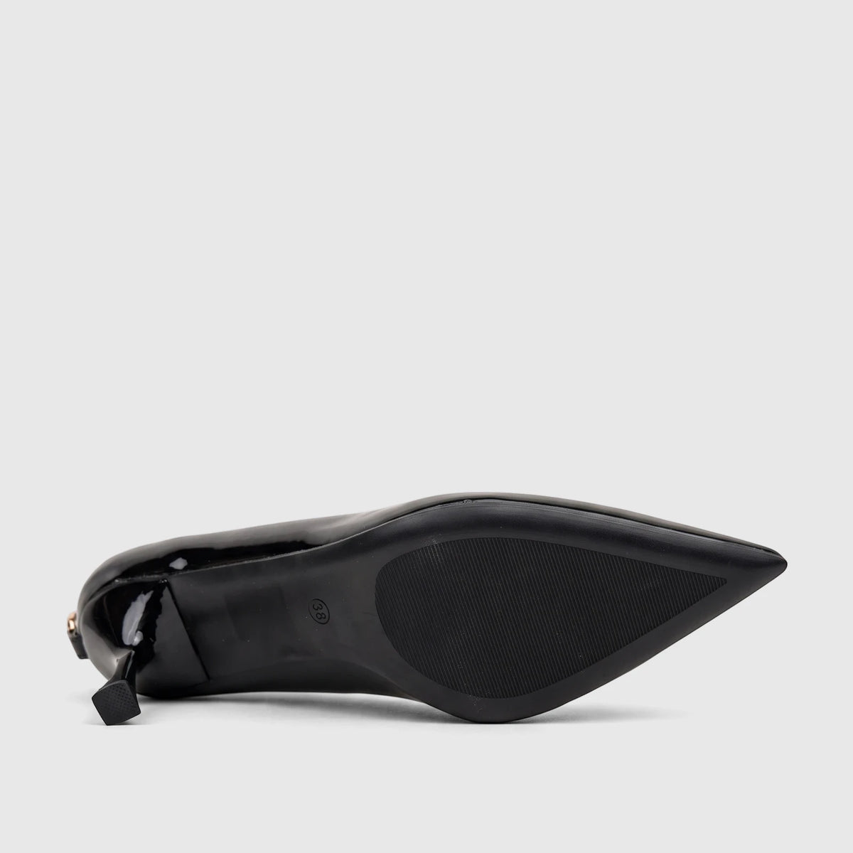 Black patent leather women's dress court shoe with a pointed toe and block heel, shown from the bottom view, displaying the