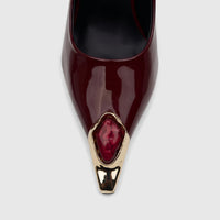 Bulbul Ladies Dress Court Shoe in glossy burgundy patent leather, featuring a pointed toe with a gold-tone and red jeweled