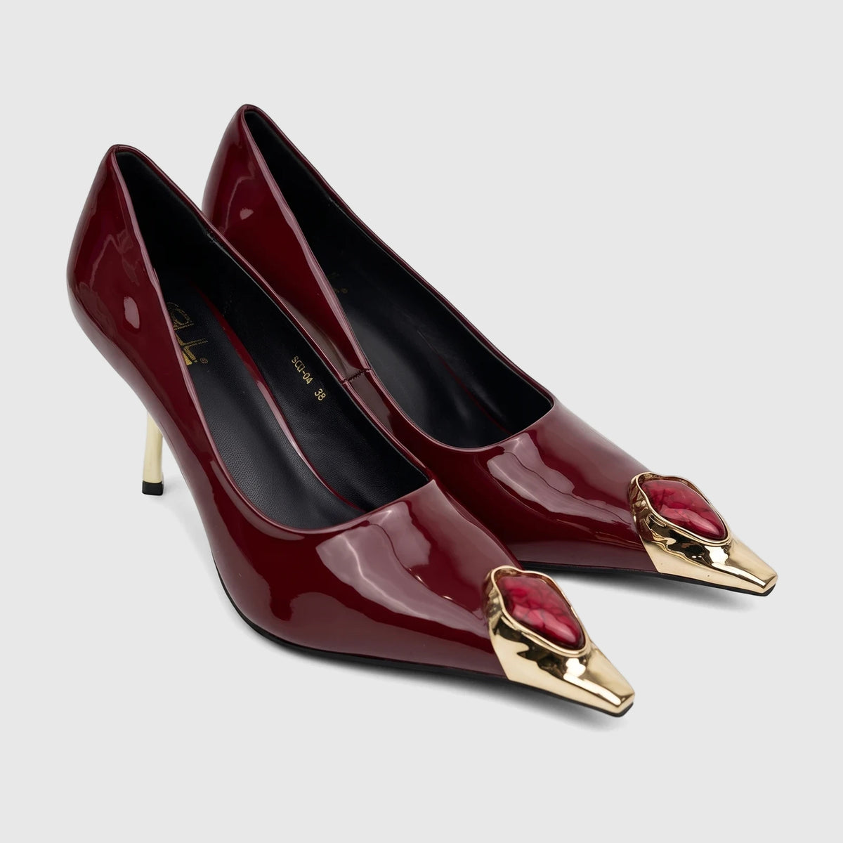 A pair of burgundy patent leather Bulbul Ladies Dress Court Shoes with pointed toes and gold and red embellishments.