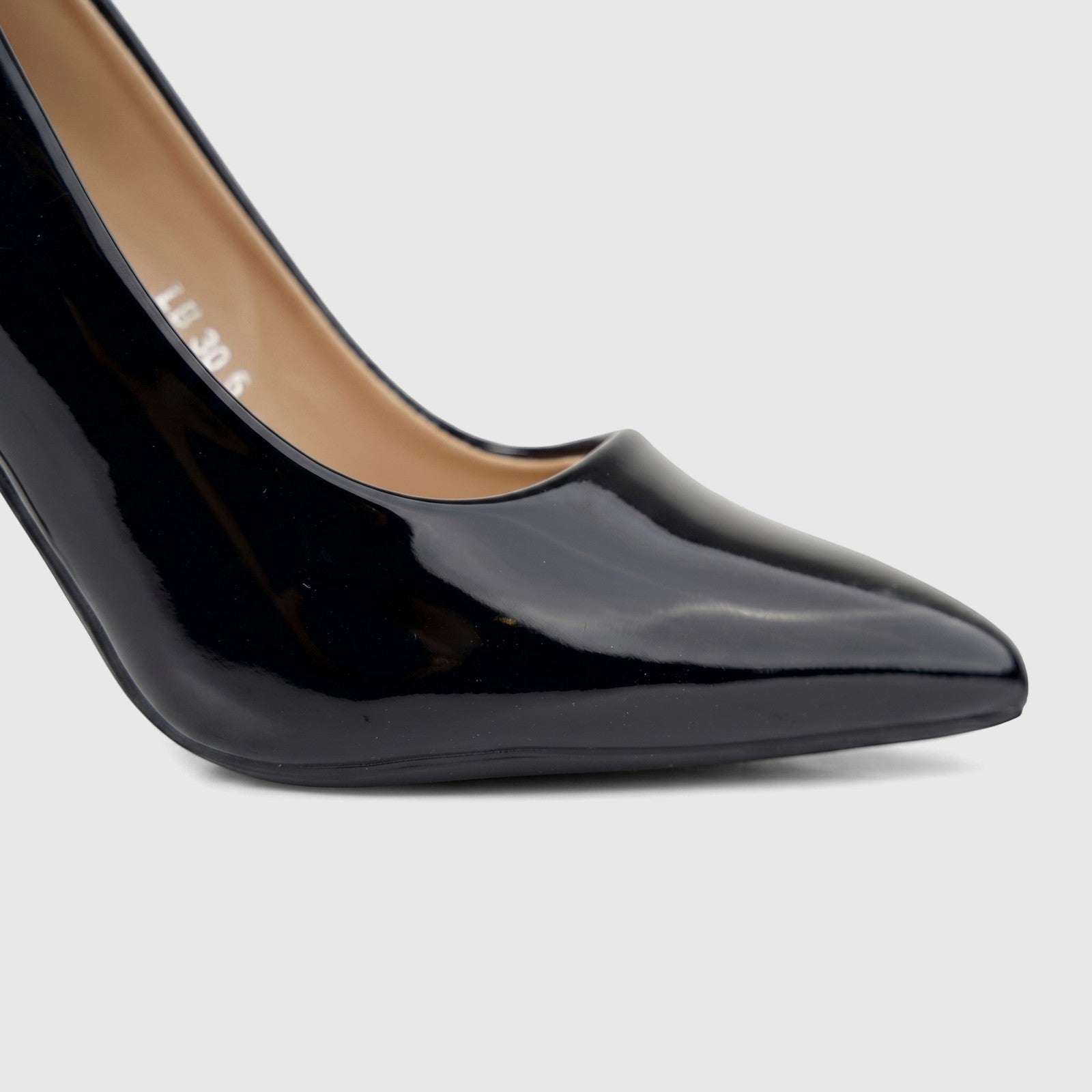 Close-up of a glossy black patent leather Bulbul Ladies Dress Court Shoe LU030, featuring a pointed toe and high heel on a
