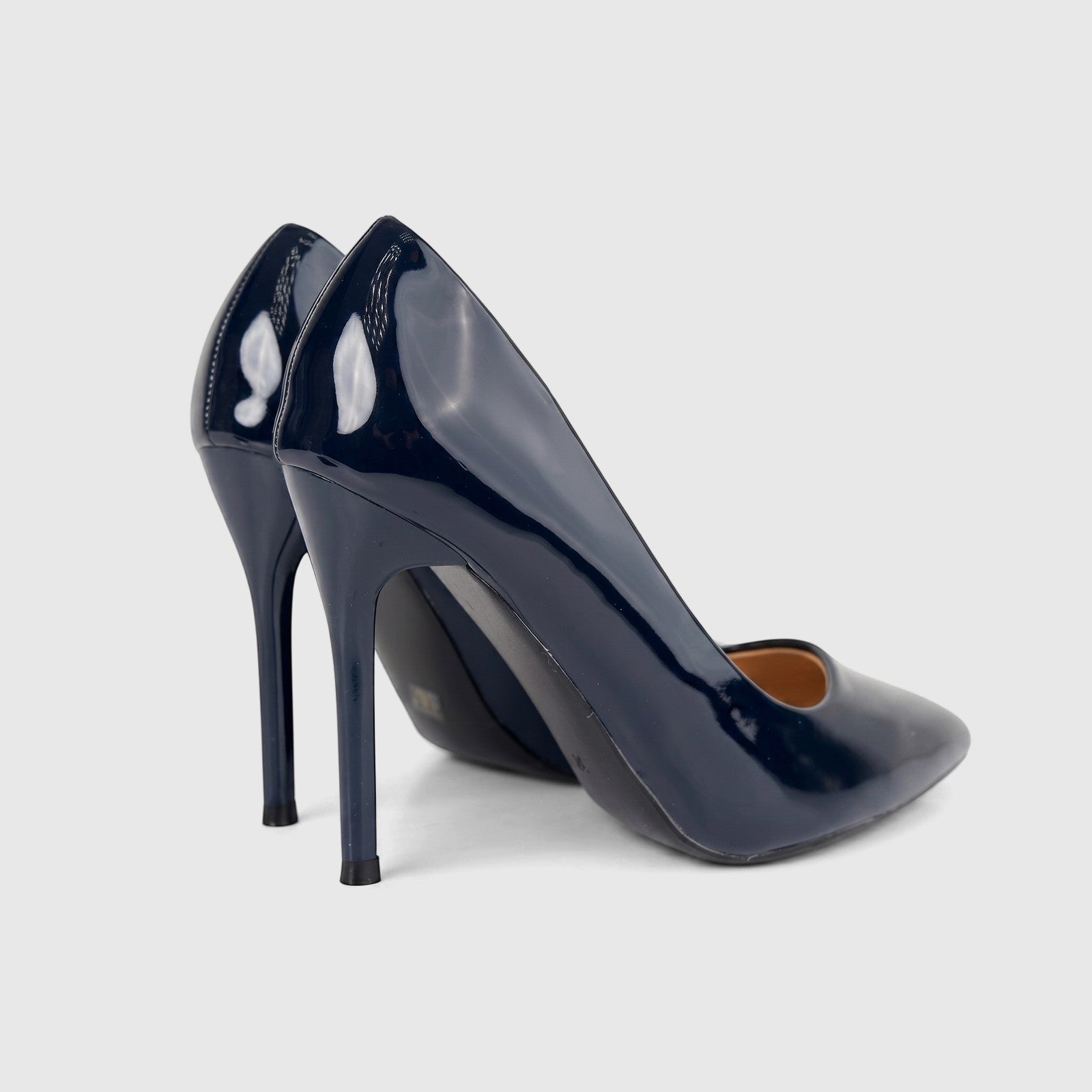 Pair of Bulbul Ladies Dress Court Shoe LU030 in navy patent leather with high stiletto heels and pointed toes.