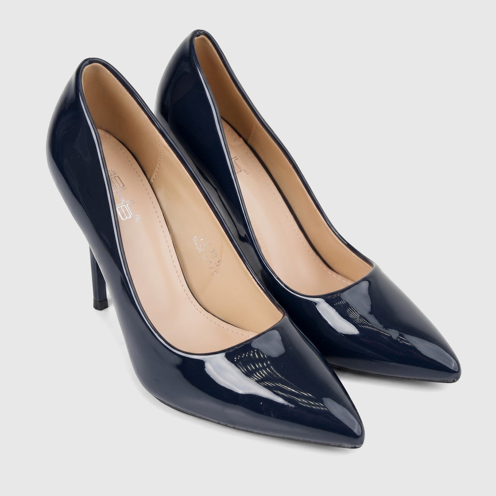 A pair of shiny navy blue patent leather Bulbul pointed-toe dress court shoes with stiletto heels, positioned on a white
