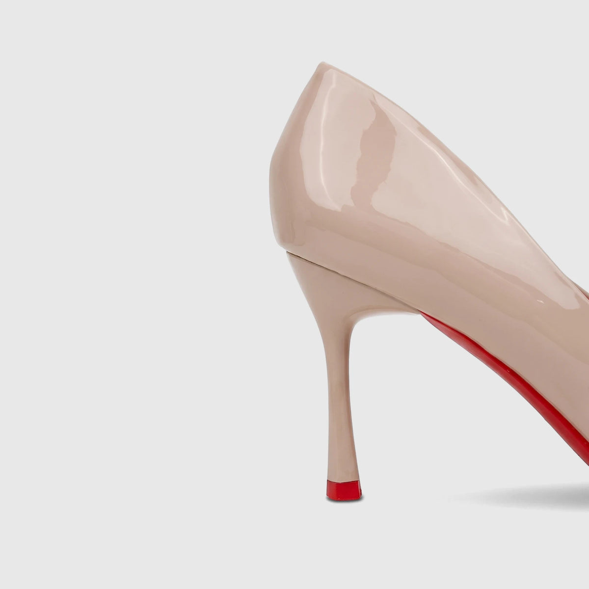 Bulbul Ladies Dress Court Shoe LU044 in nude patent leather, featuring a high heel and distinctive red sole detail, viewed