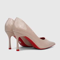 Pair of Bulbul Ladies Dress Court Shoes in nude patent leather with red soles and high heels, seen from a side view.