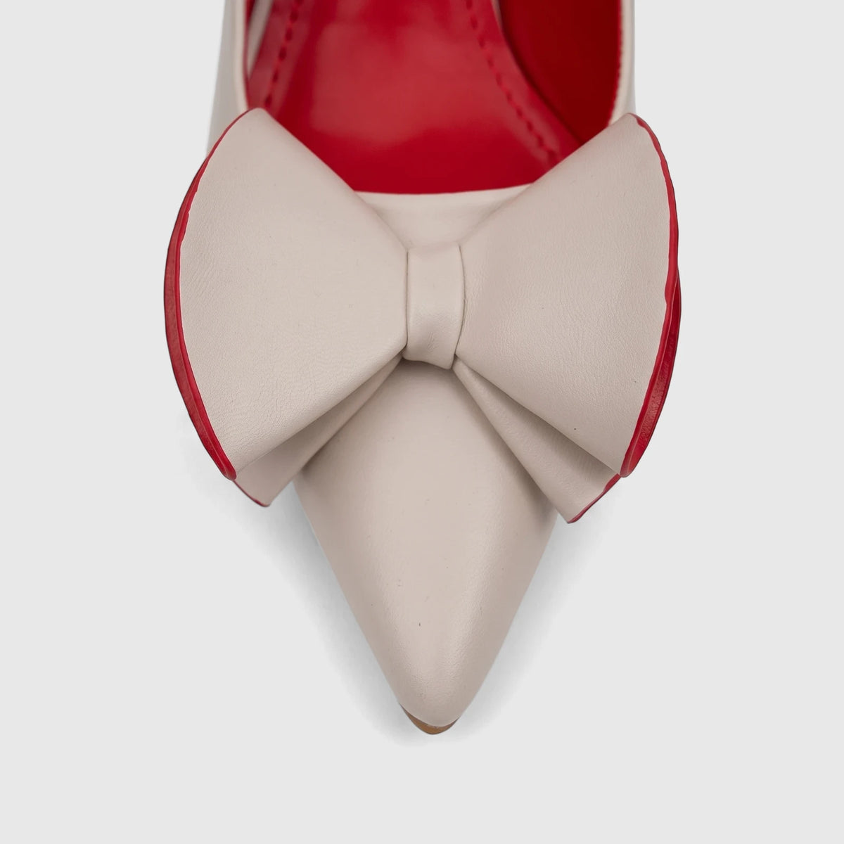 Close-up of a single beige Bulbul Ladies Dress Court Shoe with a pointed toe and a prominent red-trimmed bow detail.