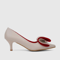 Beige ladies dress court shoe with a prominent red bow detail on the vamp, featuring a kitten heel, viewed in profile.