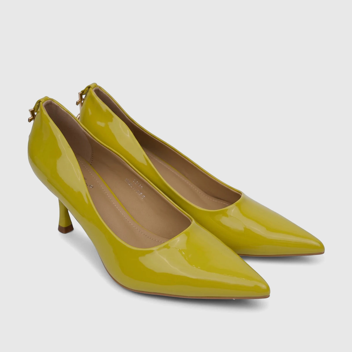 A pair of shiny mustard green (lime green) patent leather ladies' dress court shoes with pointed toes and high heels,