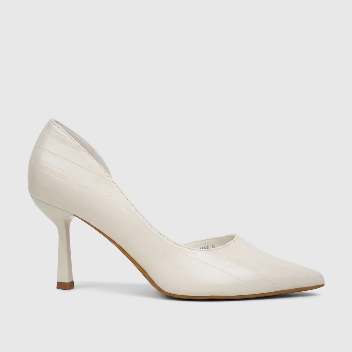 Bulbul Ladies Dress Open Waist Court Shoe in cream, featuring a pointed toe and a unique angular high heel, made with a