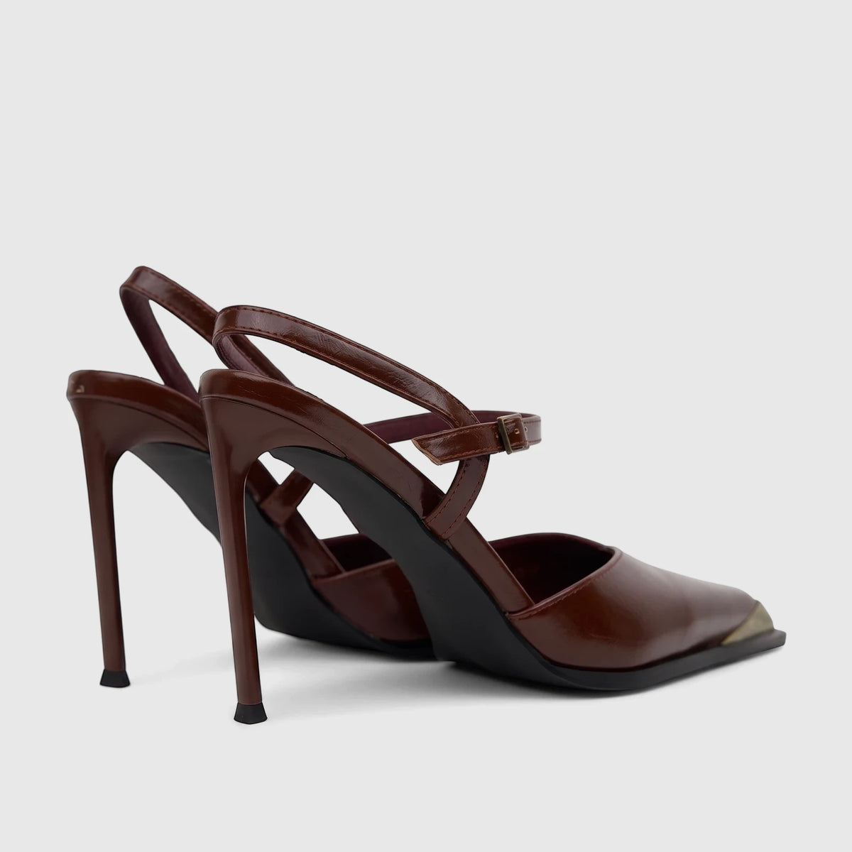 Brown leather-look stiletto high heels with slingback strap and gold cap toe, seen from a rear-quarter view.