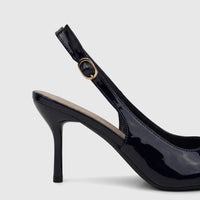 A close-up view of a single Bulbul Ladies Dress Slingback Court shoe in navy patent leather, featuring a high heel and gold