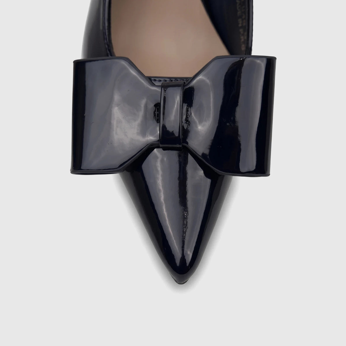 Close-up of a navy patent leather Bulbul Ladies Dress Slingback Court pump, featuring a pointed toe and a prominent