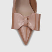 Close-up view of a Bulbul Ladies Dress Slingback Court in nude patent leather, featuring a pointed toe and a large