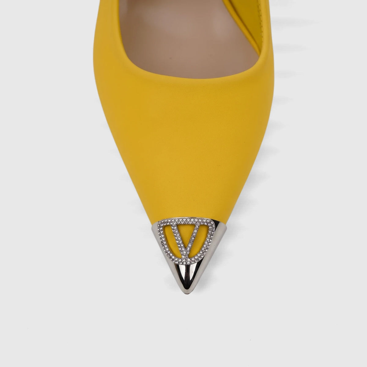 Close-up of a yellow Bulbul Ladies Dress Slingback Court shoe, featuring a pointy toe adorned with a silver