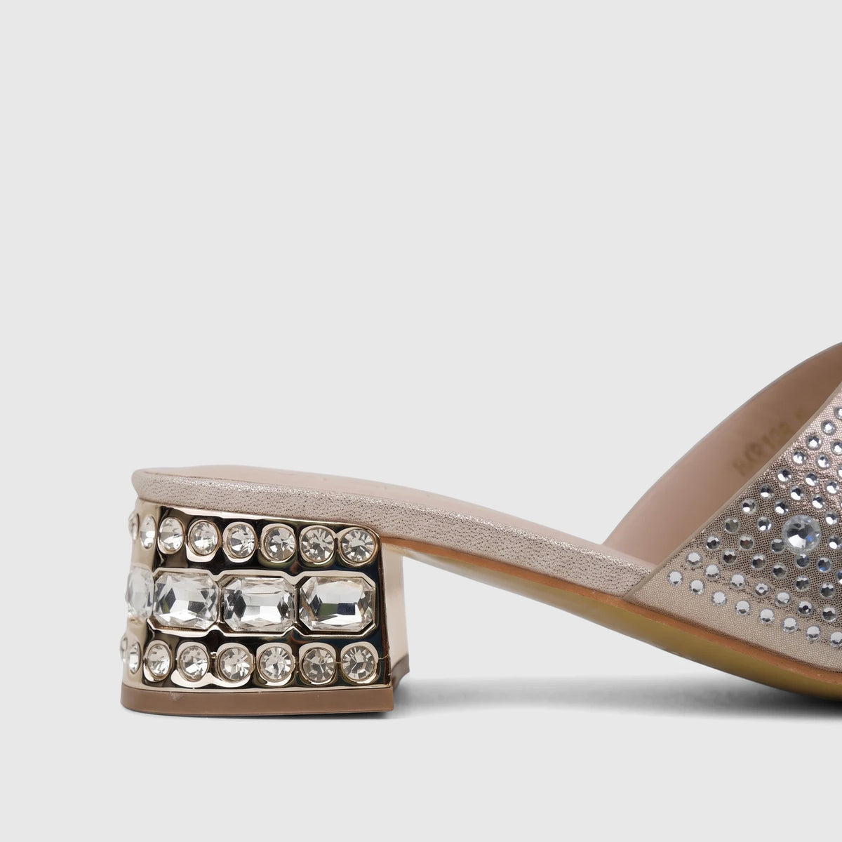 Gold block heel mule with crystal embellishments on the heel, designed for ladies' evening wear.