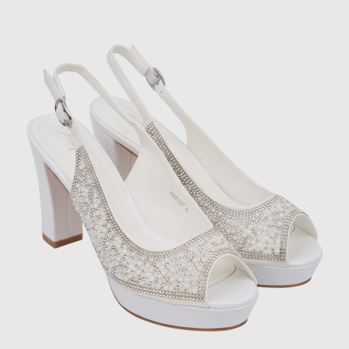 White block heel peep toe sandals adorned with pearls and rhinestones, featuring transparent straps and a platform sole.
