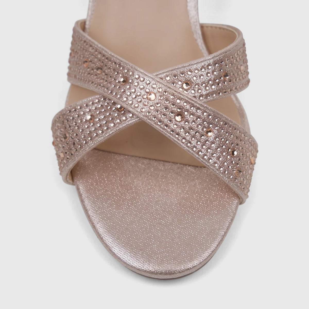 Close-up of a champagne Bulbul Ladies Evening Block Heel Sandal, featuring a glitter finish and rhinestone-embellished