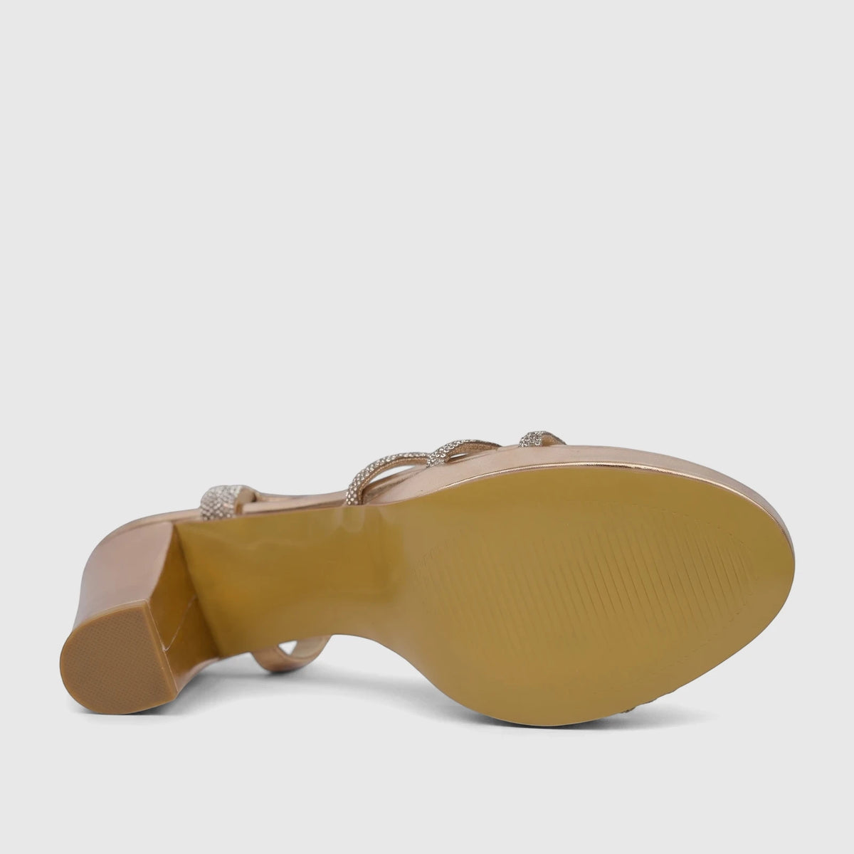 Bulbul Ladies Evening Block Heel Sandal in champagne, showcasing the textured sole, sturdy block heel, and shimmering
