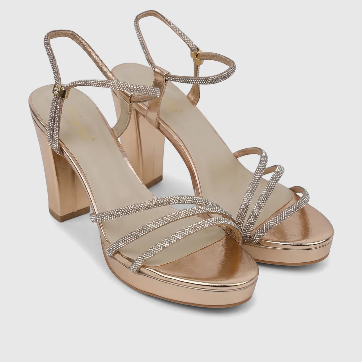 A pair of Bulbul Ladies Evening Block Heel Sandals in champagne, featuring sparkling rhinestone-embellished straps and a