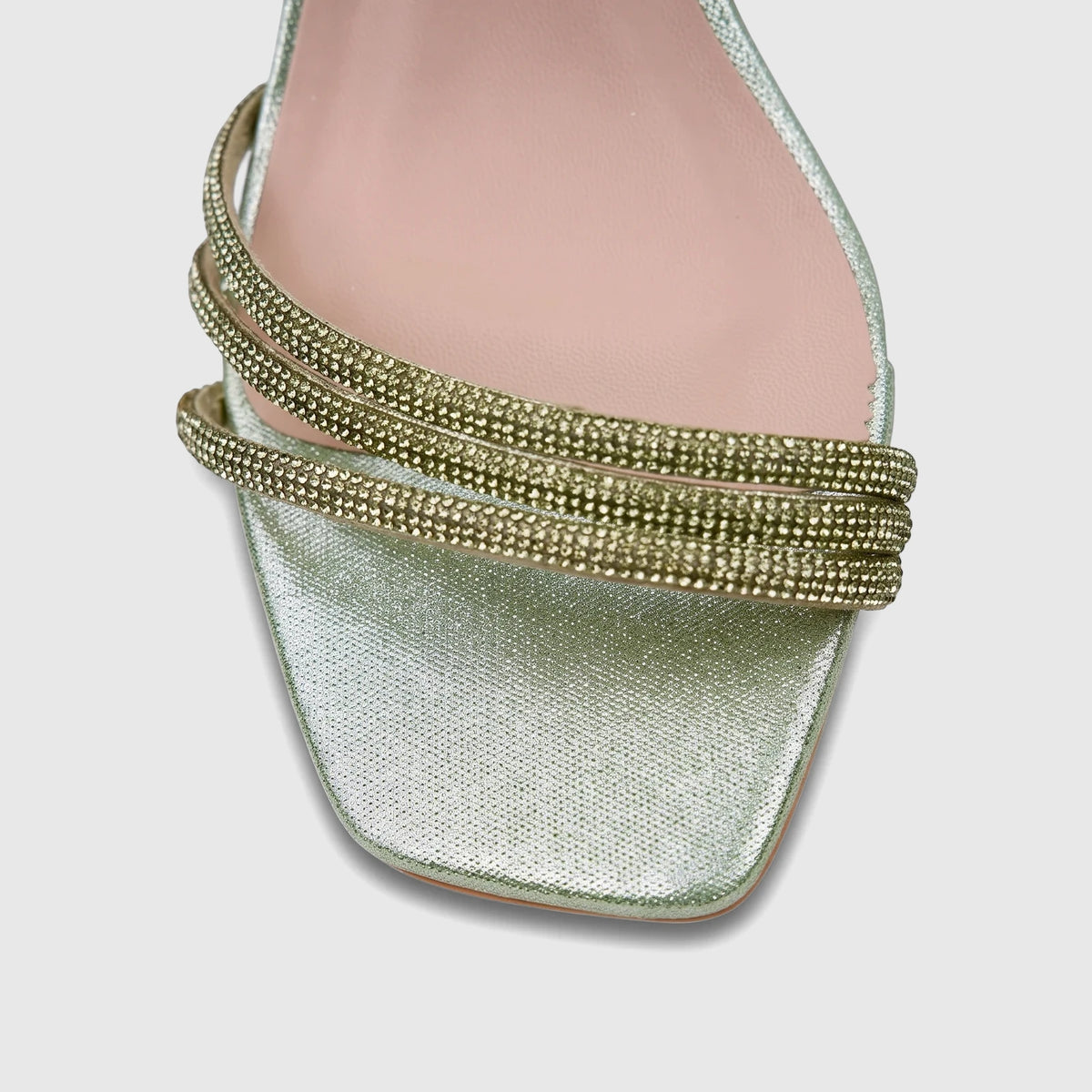Close-up of a green Bulbul Ladies Evening Block Heel Sandal featuring sparkling rhinestone straps and a modern square toe