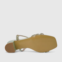 Green glitter block heel sandal for ladies, viewed from the bottom showing the light brown sole and square toe.