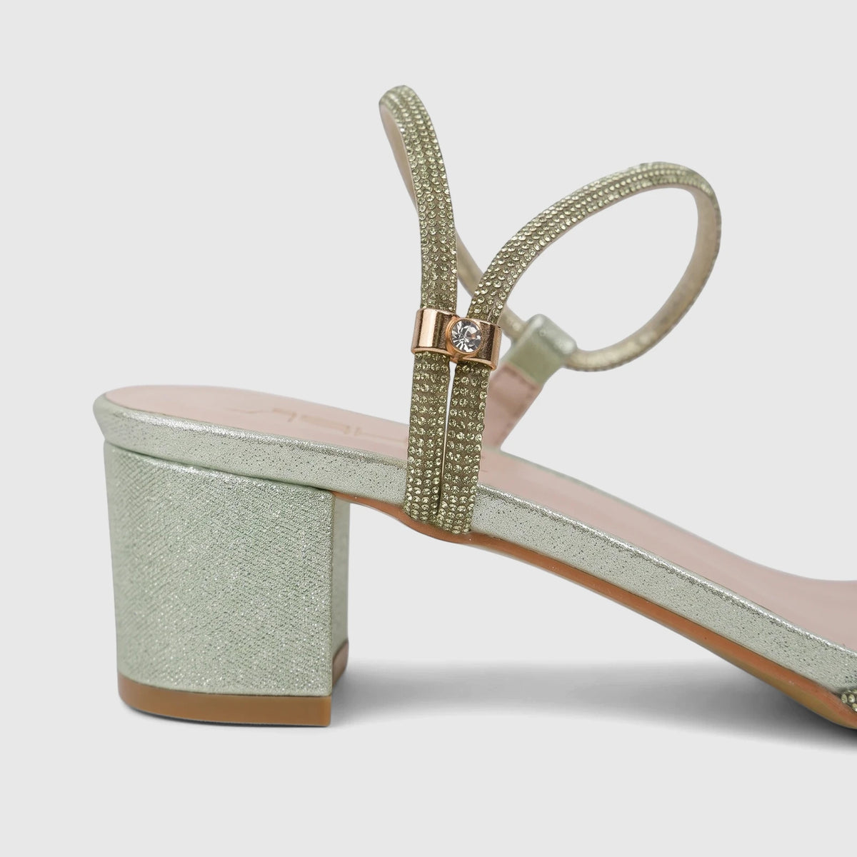 Close-up of a Bulbul Ladies Evening Block Heel Sandal in green with sparkling straps and a diamond buckle.