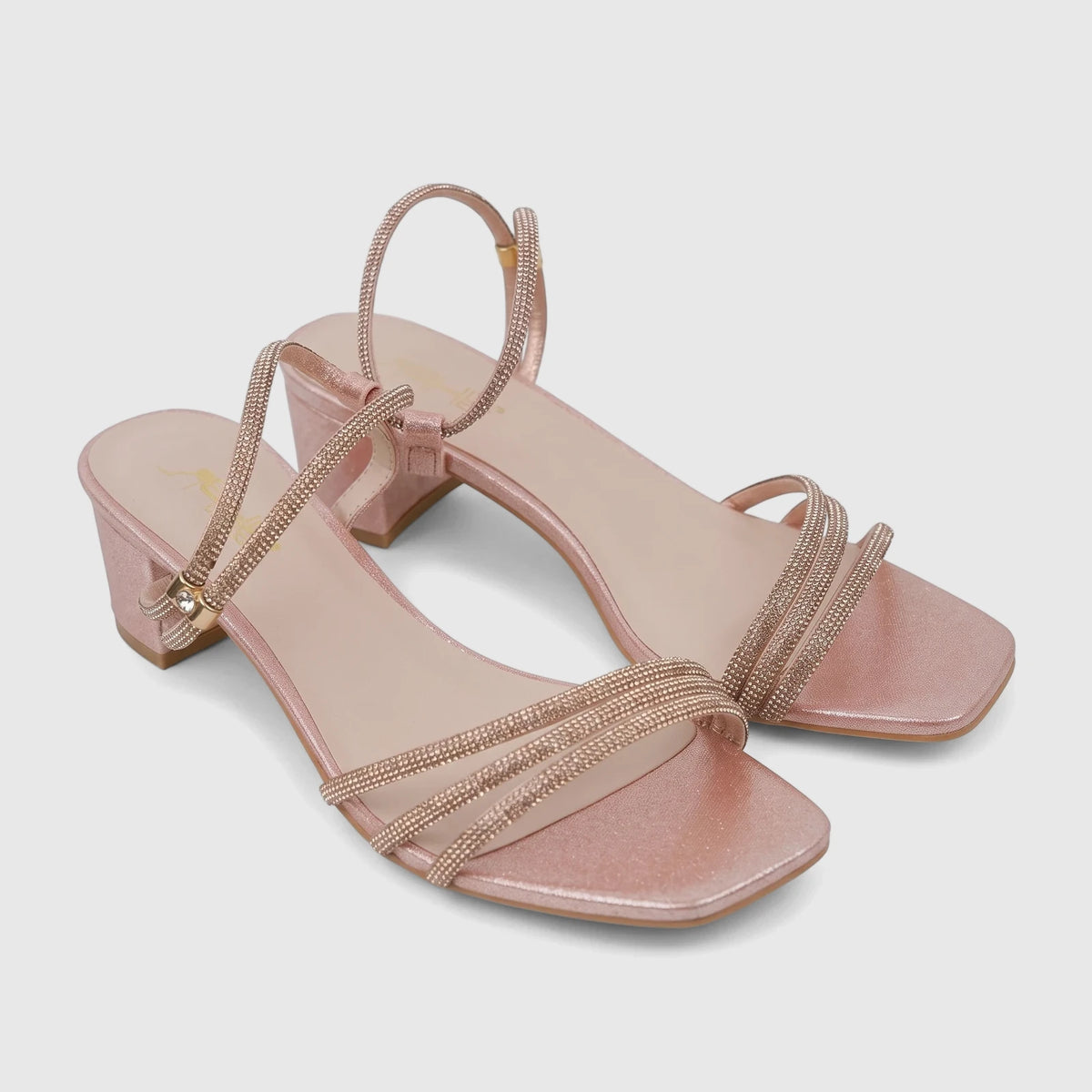 A pair of elegant pink Bulbul Ladies Evening Block Heel Sandals, featuring shimmering material and rhinestone-embellished