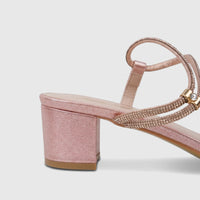 Pink glitter block heel sandal with sparkling straps and a gold-tone accent, designed for evening wear.